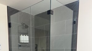 A glass-enclosed shower area with a tiled floor and a glass partition. - Cozy 3-bed mtn condo in village, walkable to all! (Slaty Fork)