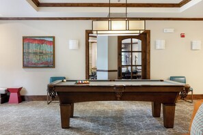A pool table in a room with a wooden ceiling, a framed abstract painting, and a carpeted floor. - Ascent Condo 310 | 3BR Downtown Avon Condo, Sleeps 6, Indoor Pool (Beaver Creek)