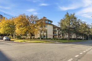 A multi-story residential building with a flat roof and a balcony on the second floor. - Stylish 2-bed Apartment in Kingston (Canberra)