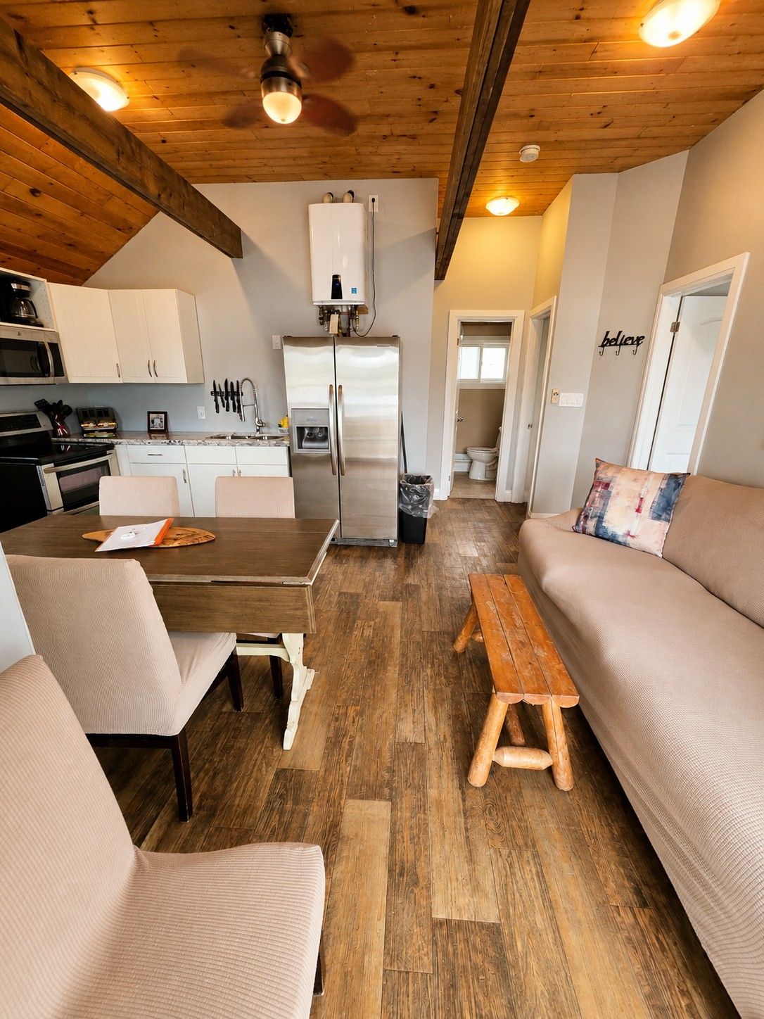 A compact living space with a kitchenette, a dining area, and a seating area.