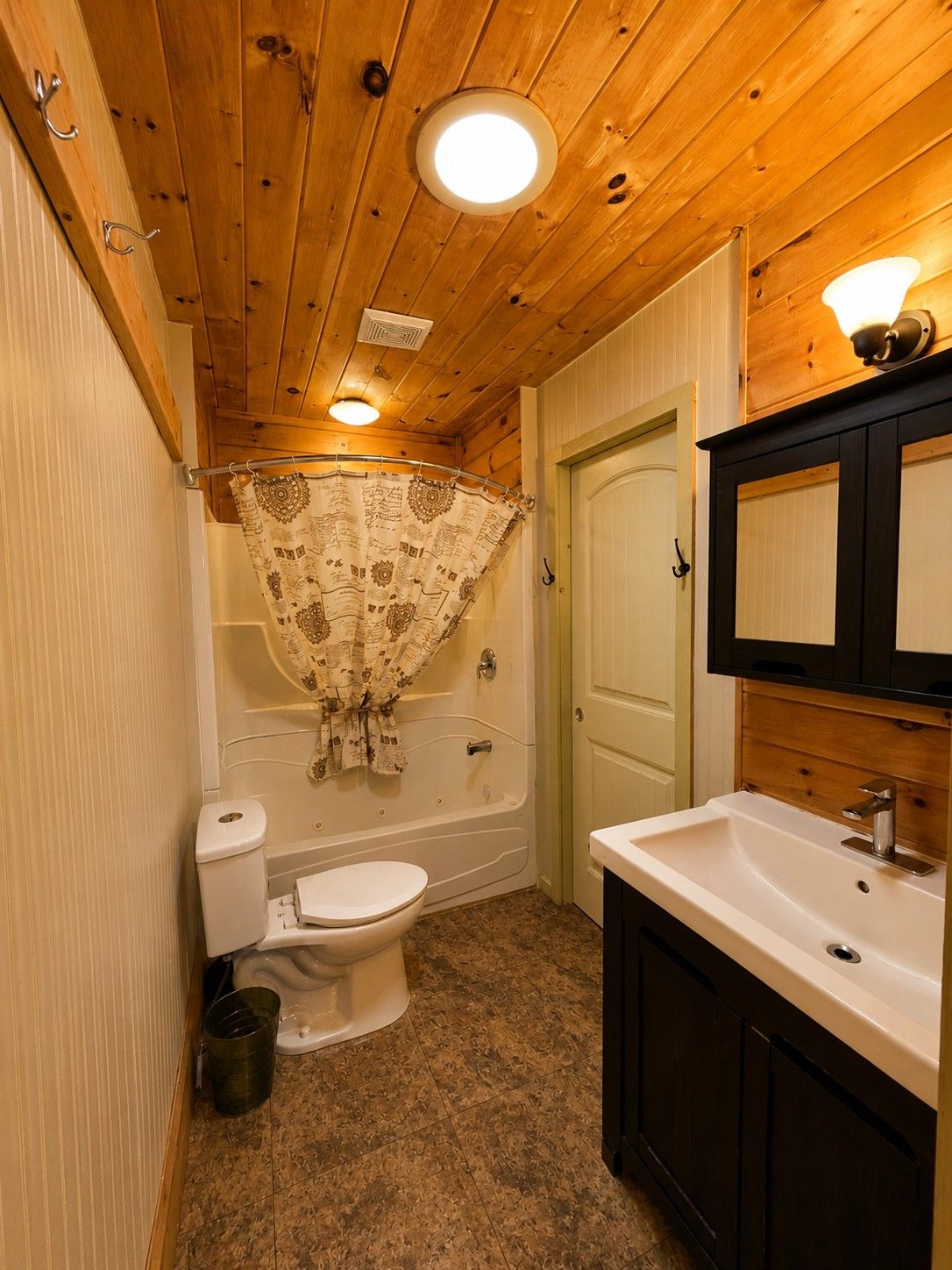 A bathroom with a toilet, bathtub, and sink.