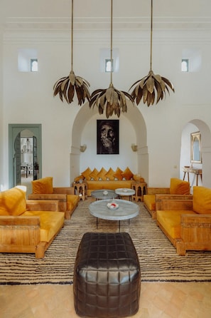A spacious living room with a sofa set, a coffee table, and a large ottoman. - Villa in Marrakech, with a private pool (Marrakech)