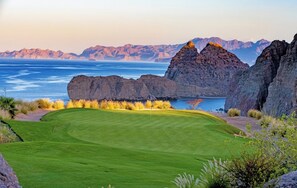 A golf course with a clear view of the ocean and mountains in the background. - One bedroom suite at Villa Del Palma at the Islands of Loreto (Loreto)