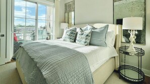 A bedroom with a bed, a nightstand, a lamp, and a large window. - The Butler, Walk SQ & Campus by Velvet Ditch Villas (Oxford)