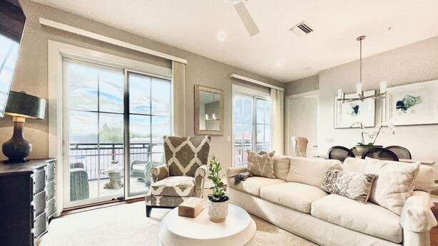 A spacious living room with a large window, a sofa, a coffee table, and a fireplace. - The Butler, Walk SQ & Campus by Velvet Ditch Villas (Oxford)