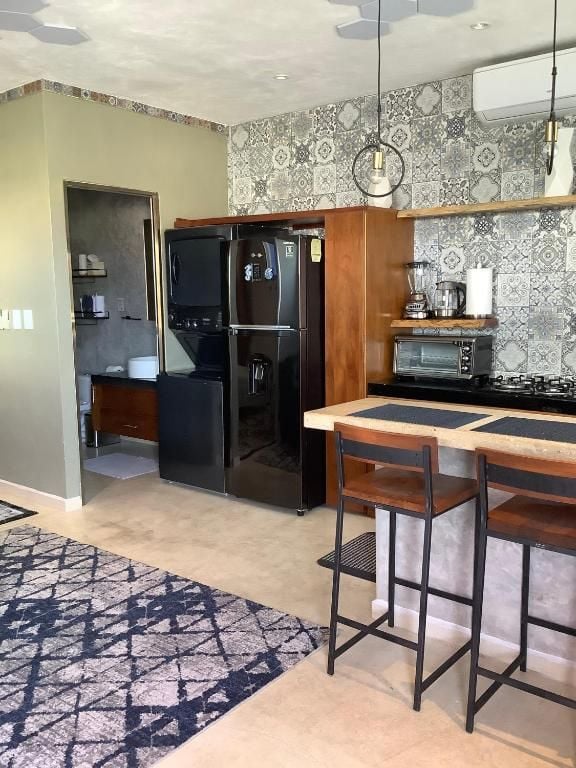 A modern kitchen with a built-in refrigerator, microwave, and bar stools.