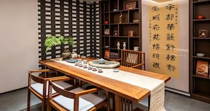 A traditional dining area with a wooden table, chairs, and a decorative wall.