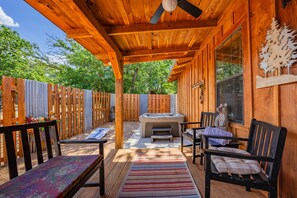 An outdoor wooden deck with a hot tub, seating area, and a pergola with a ceiling fan. - Saw Mill (Lodge #4) Hot Tub & 10 Mins to Main St (Fredericksburg)