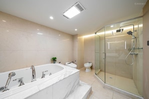 A modern bathroom with a large bathtub, a glass-enclosed shower, and a toilet. - Tonight Homestay East Nanjing Road Shanghai (Shanghai)