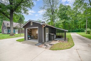 A single-story building with a garage, open shelving, and a covered outdoor area.