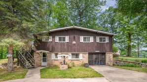 A two-story house with a brick facade, a front porch, and a visible garage door. - Lodge No Complaints - Harrison (Harrison)