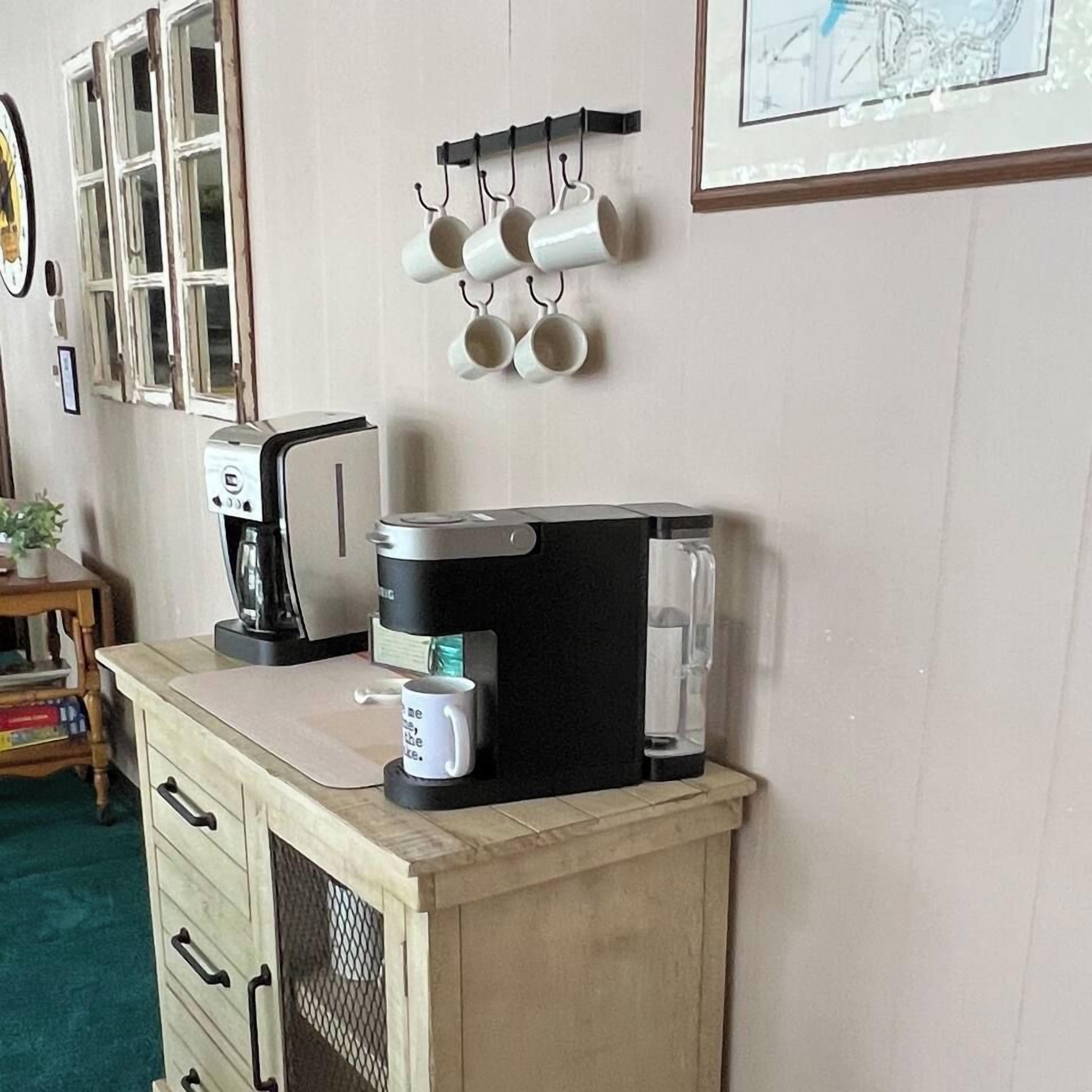 Une petite cuisine équipée d’une machine à café, d’un grille-pain et d’un porte-tasses.