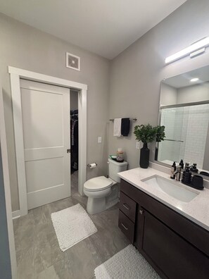 A modern bathroom with a toilet, sink, and mirror. - Peaceful Grandview Escape Minutes from Downtown (Columbus)