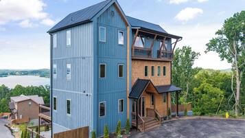 A two-story building with a blue exterior and a wooden deck.