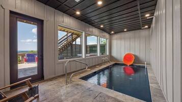 A swimming pool with a view of a staircase leading outside.