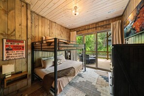 A bunk bed room with a poster on the wall, a window, and a view of the outdoors. - Private Dock-Lakefront-Views-Pets-Beach Access (Sevierville)