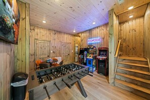 A room with wooden walls, a foosball table, and arcade games. - Private Dock-Lakefront-Views-Pets-Beach Access (Sevierville)