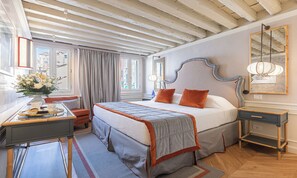 A bedroom with a large bed, bedside tables, a desk with a chair, and a window with curtains. - SPECTACULAR VENETIAN APARTMENT OVERLOOKING CAMPO SAN MAURIZIO (Venezia)