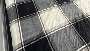 A bed with a checkered bedspread and two pillows. - 1880 Yellow-Brick Cottage Executive Retreat (London)
