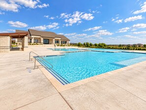 A swimming pool with a clear blue sky and a building in the background. - Upscale 3BR - 2.5 Bathroom Home with 2 Living Rooms + Gym & Pool (Cresson)