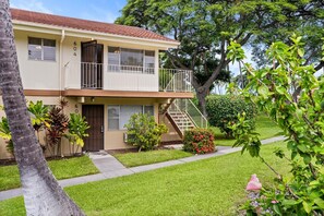 A two-story residential building with a balcony, a front door, and a staircase leading to the second floor. - Keauhou Palena #604 Kona Retreat With A/C (Kailua-Kona)