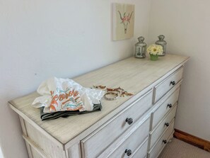 A light wooden dresser with multiple drawers, a decorative item on top, and a small framed picture on the wall. - Foosball, Fireplace, Deck, Views, Guest Favorite (Alpine)
