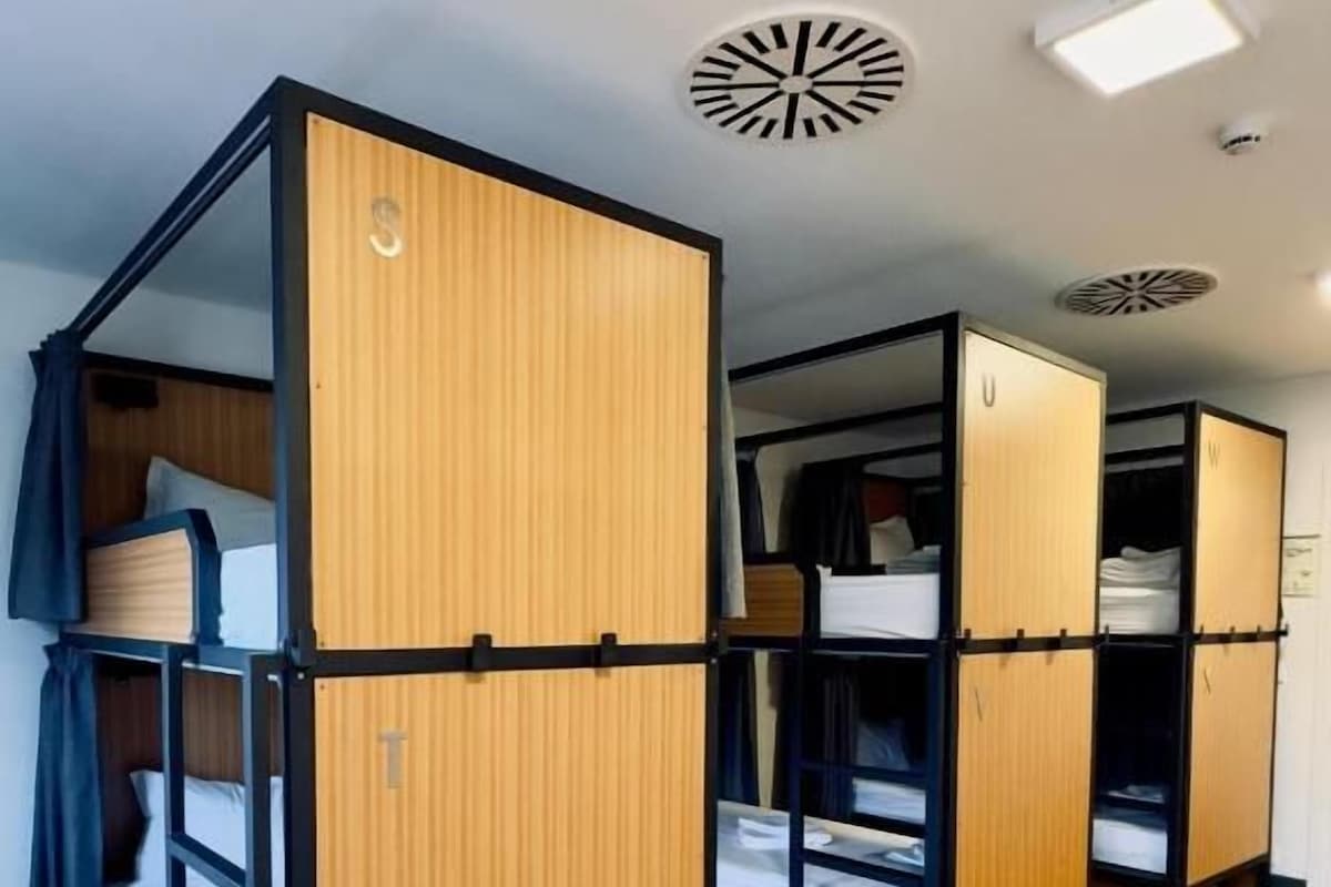 A room with bunk beds and a wardrobe.