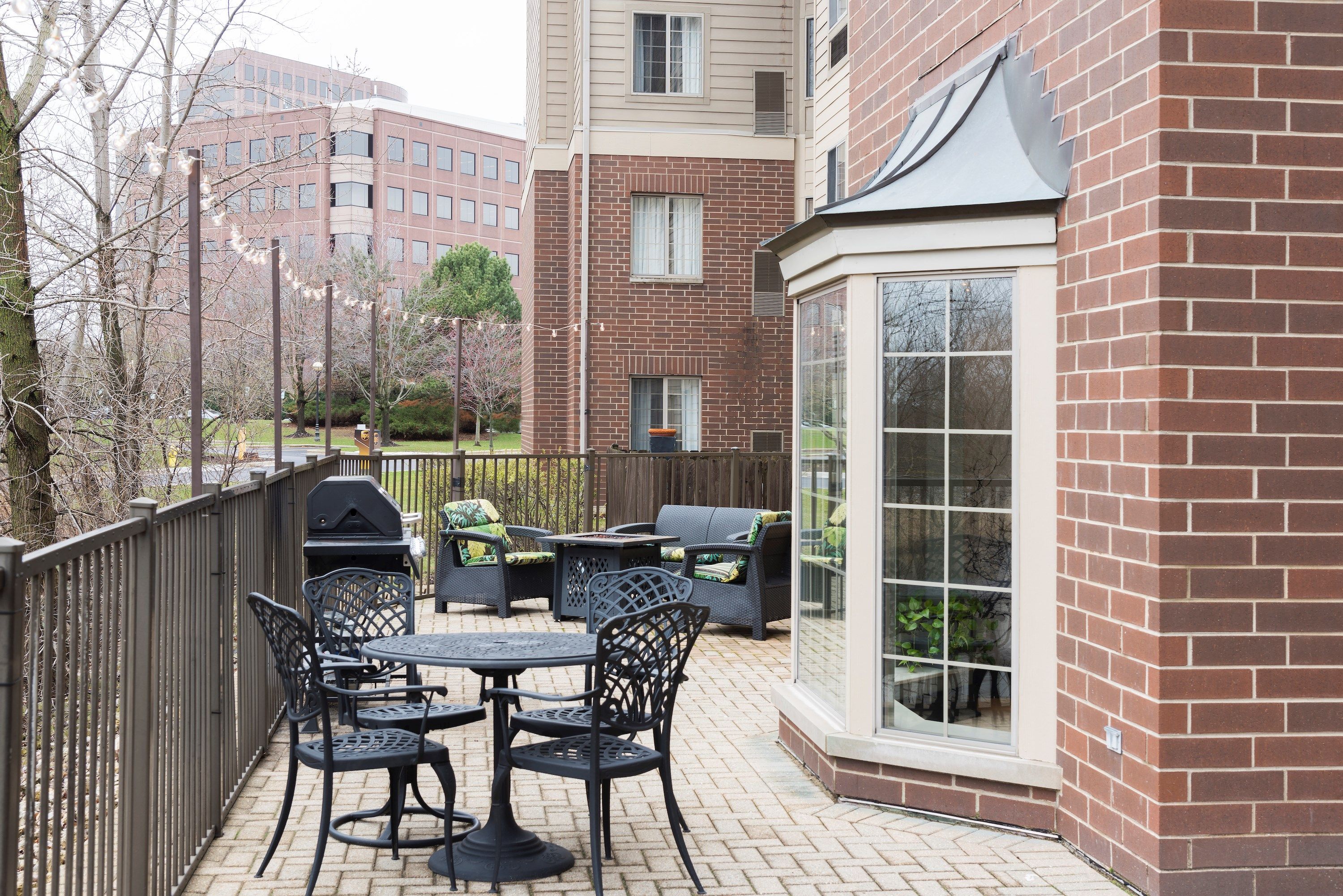 Patio deck with outdoor seating and gas grill.
