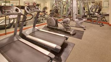 A gym with treadmills, elliptical machines, and weight equipment.