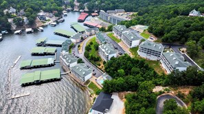 A riverside property with multiple buildings, docks, and a swimming pool. - Emerald Escape Lake Views (Lake Ozark)