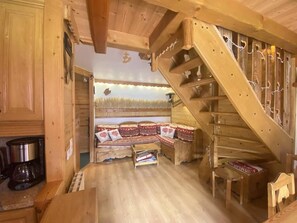 A wooden interior with a staircase, a sofa with patterned cushions, and a coffee maker on the counter. - Ski-in/ski-out & foot of the slopes, 3rd floor, balcony, ski locker, 52m², Valmorel (Valmorel)