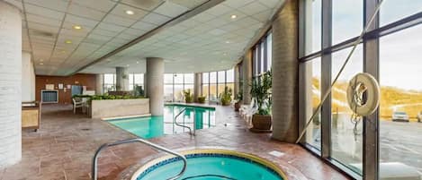 Unwind in the facilities rejuvenating hot tub, surrounded by natural light streaming through floor-to-ceiling windows.