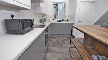 A modern kitchen with a microwave, toaster, and sink.