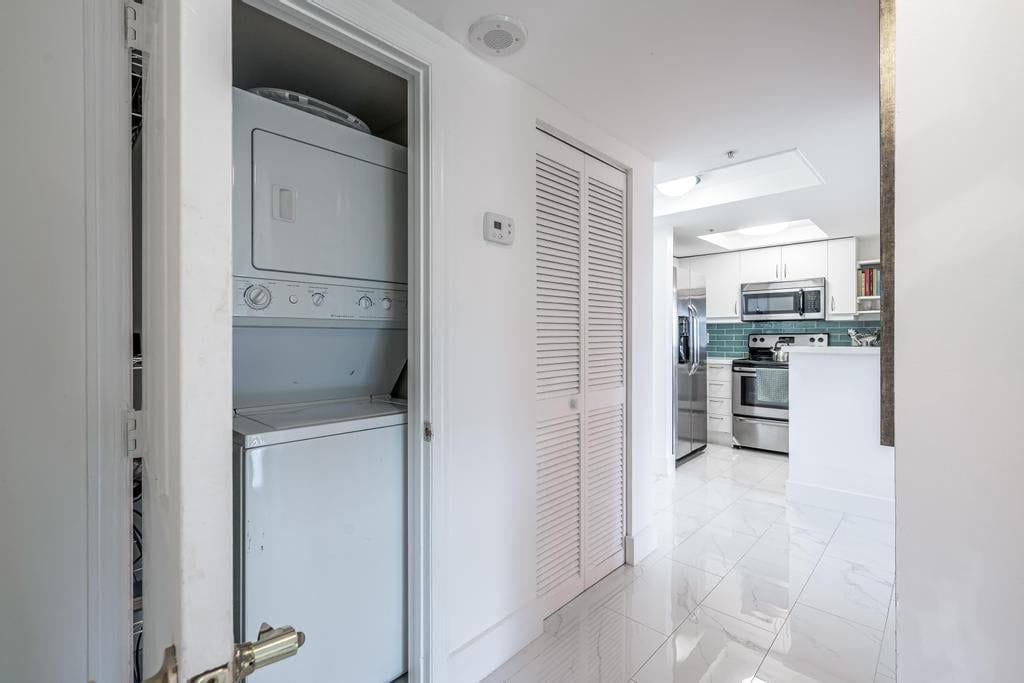 A modern kitchen with a microwave, oven, and a built-in dishwasher.