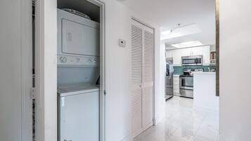 A modern kitchen with a microwave, oven, and a built-in dishwasher.