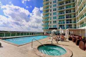 A rooftop pool area with a hot tub, lounge chairs, and a view of the ocean. - Coconut Grove: 10th Floor Private Unit -parking Included (Miami)