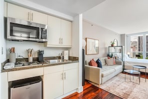 A modern kitchen with a built-in microwave, a coffee machine, and a refrigerator. - Coconut Grove Studio: Sleeps 4 Includes Parking (Miami)