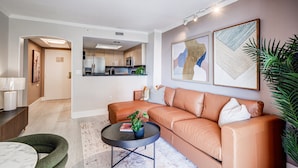 A modern living room with a leather sofa, a coffee table, and a dining area with a lamp. - Coconut Grove Beauty! 1/1 Bayview Condo w/ Free Parking (Miami)