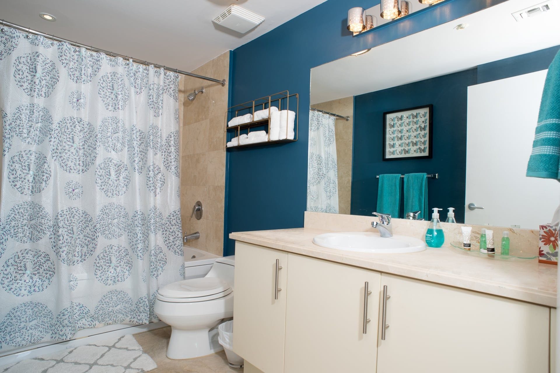 A bathroom with a shower, toilet, and sink.