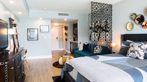 A modern bedroom with a large bed, a TV, and a dining area with a table and chairs. - Deluxe Studio in Coconut Grove-city & Bay Views...includes Parking (Miami)