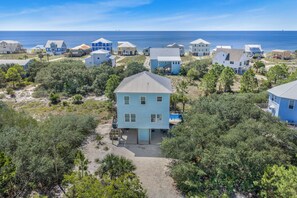 A coastal residential area with multiple houses, a clear view of the ocean, and a sandy beach. - Private Beach · Heated Saltwater Pool · Ocean View (Gulf Shores)