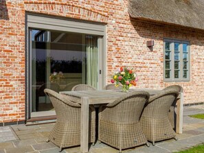 A brick building with a large glass door and a window. - Holiday Home Sylt 44 (Wenningstedt-Braderup)