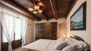 Ein Schlafzimmer mit einem Bett, einem Holzschrank und einem Bild an der Wand.