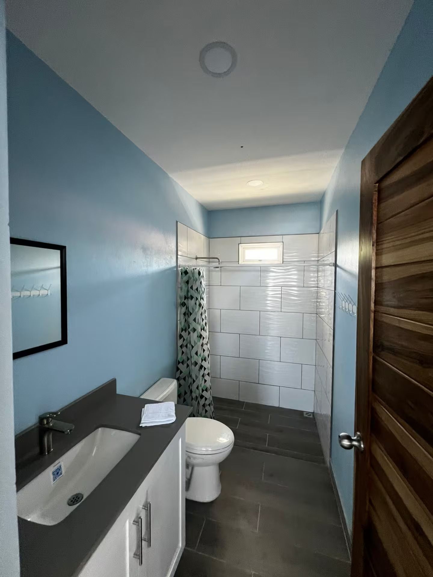 A compact bathroom with a bathtub, toilet, and shower area.