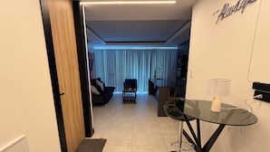 A modern living room with a glass table, a sofa, and a coffee table. - 518 RENT (Santa Cruz)