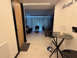 A modern living room with a glass table, a sofa, and a coffee table. - 518 RENT (Santa Cruz)