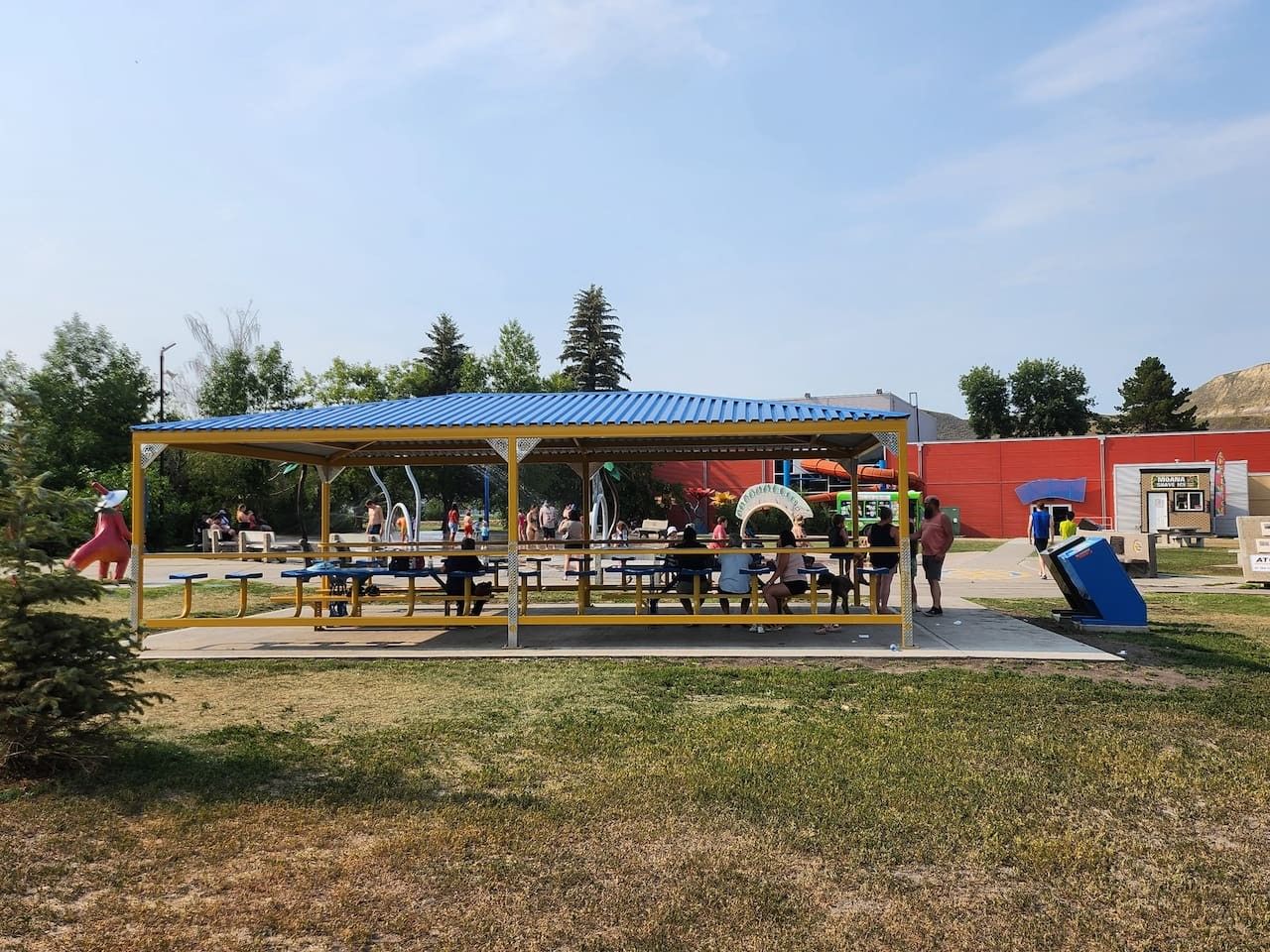 An outdoor seating area with tables and a covered pavilion.