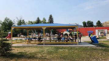 An outdoor seating area with tables and a covered pavilion.