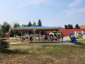 An outdoor seating area with tables and a covered pavilion.