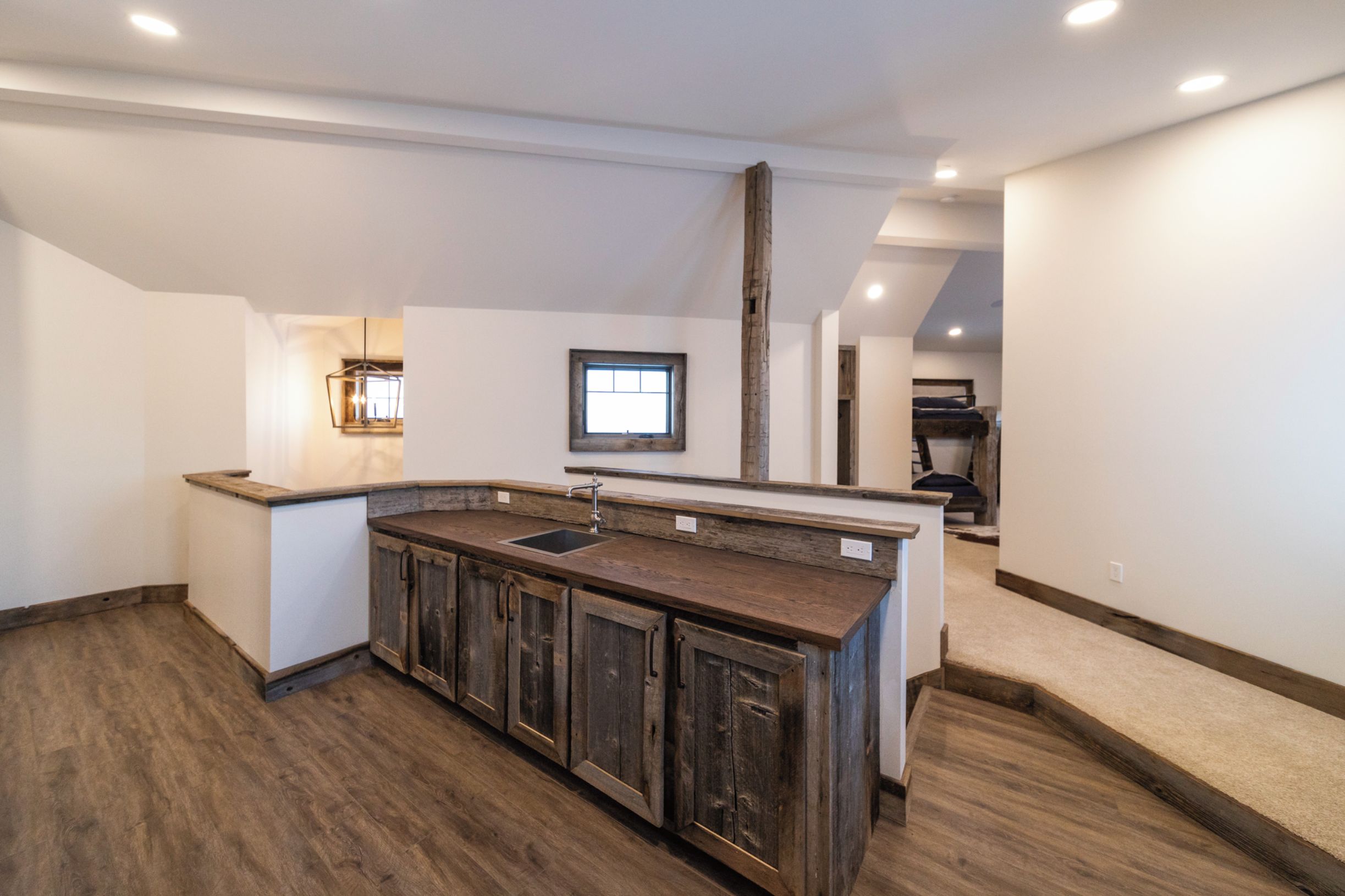 A kitchen with wooden cabinets, a sink, and a window.